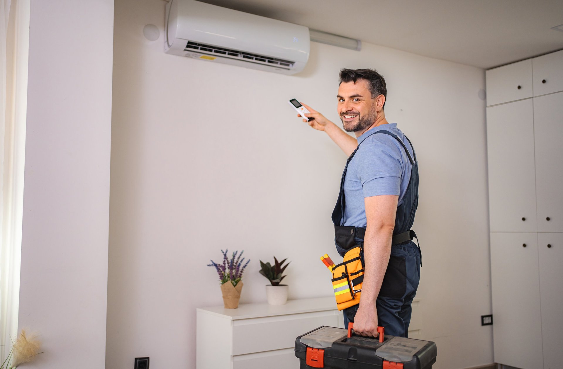 Technician installing air conditioning system